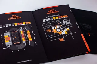 Donor booklet opened to a spread showing the football seating map and parking map